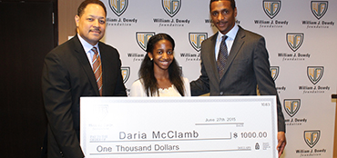 A scholarship recipient receiving an award at a foundation event