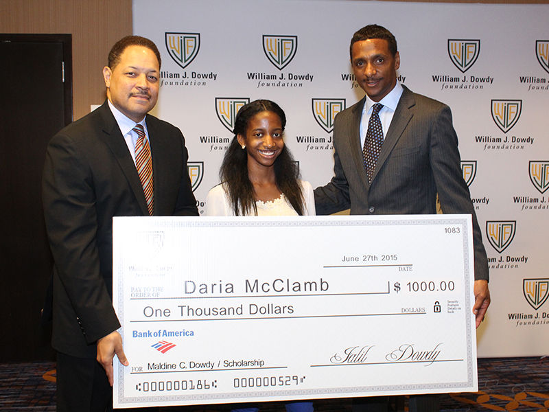 Daria McClamb holding a scholarship award check