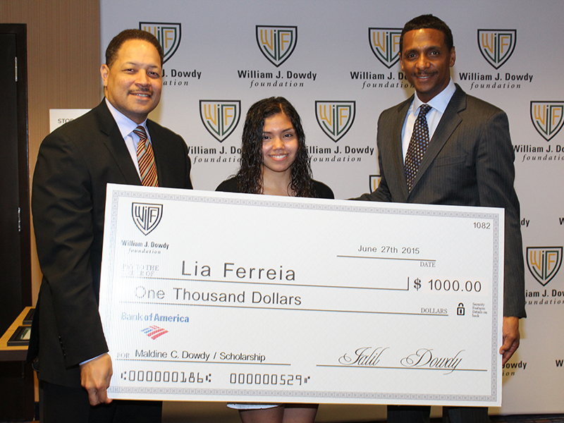 Lia Ferreira holding a scholarship award check